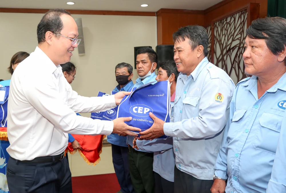 Phó Bí thư Thành ủy TPHCM Nguyễn Hồ Hải trao vốn và quà hỗ trợ cho công nhân. Ảnh: THẢO LÊ 