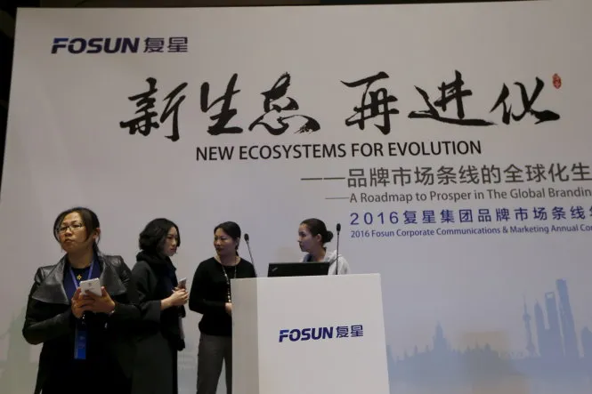 Nhân viên Fosun trong hội nghị thường niên ngày 14-12 - Ảnh: Reuters