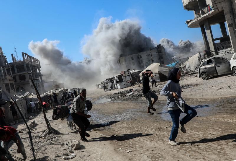 9月8日，加沙城一座高层建筑遭以色列军队空袭后升起浓烟，民众纷纷躲避