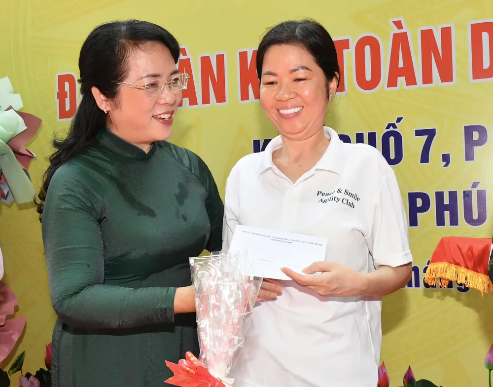 Chủ tịch Ủy ban MTTQ Việt Nam TPHCM Trần Kim Yến trao quà đến các hộ dân có hoàn cảnh khó khăn. Ảnh: VIỆT DŨNG