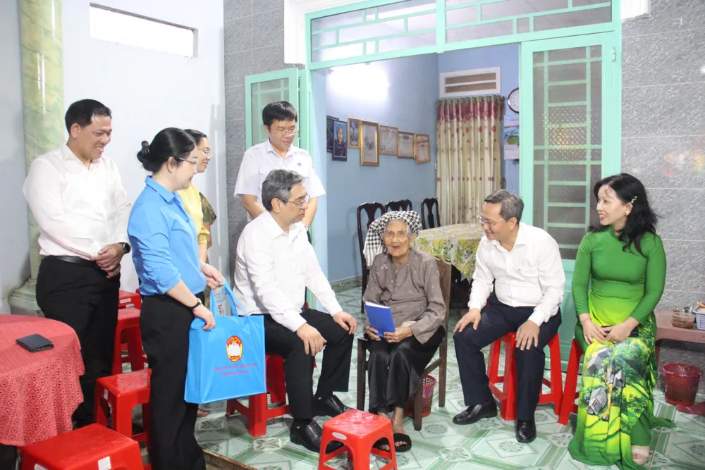 Đồng chí Nguyễn Phước Lộc thăm hỏi sức khỏe Mẹ Rực cùng gia đình. Ảnh: TÂM TRANG z7168190811044_c56f9989df086470717ec8ae8b7b3364.jpg