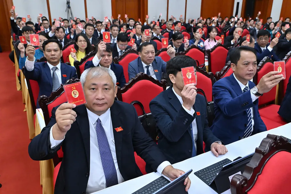 Các đại biểu thực hiện biểu quyết chương trình đại hội. Ảnh: VIẾT CHUNG DH Dang bo Van phong TW 8.jpg