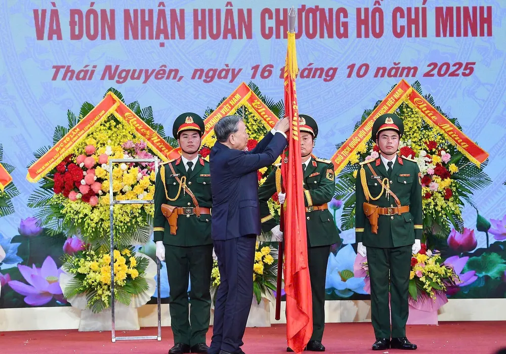 Tổng Bí thư Tô Lâm gắn Huân chương Hồ Chí Minh lên Quân kỳ quyết thắng Quân khu 1 tại buổi lễ. Ảnh: VIẾT CHUNG TBT To Lam - Quan khu 1 D.jpg