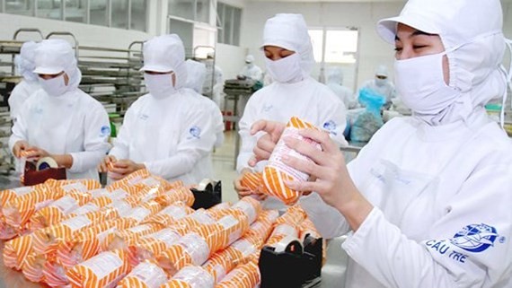 Workers of processed food manufacturer Cau Tre are making food  for local consumption (Photo: SGGP)