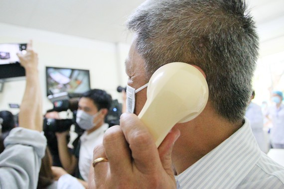 Deputy Minister of Health Nguyen Truong Son (L) communicates with Vietnamese American COVID-19 patient who is allowed to be discharged from the hospital (Photo: SGGP)