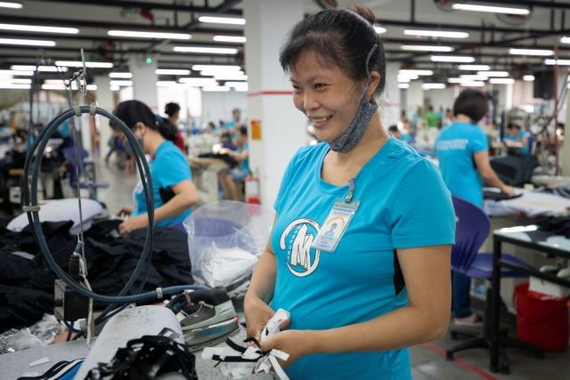 Tinh Nguyen, a seamstress for Maxport Limited Vietnam works on an assembly line in its Hanoi factory. Photo courtesy of IFC