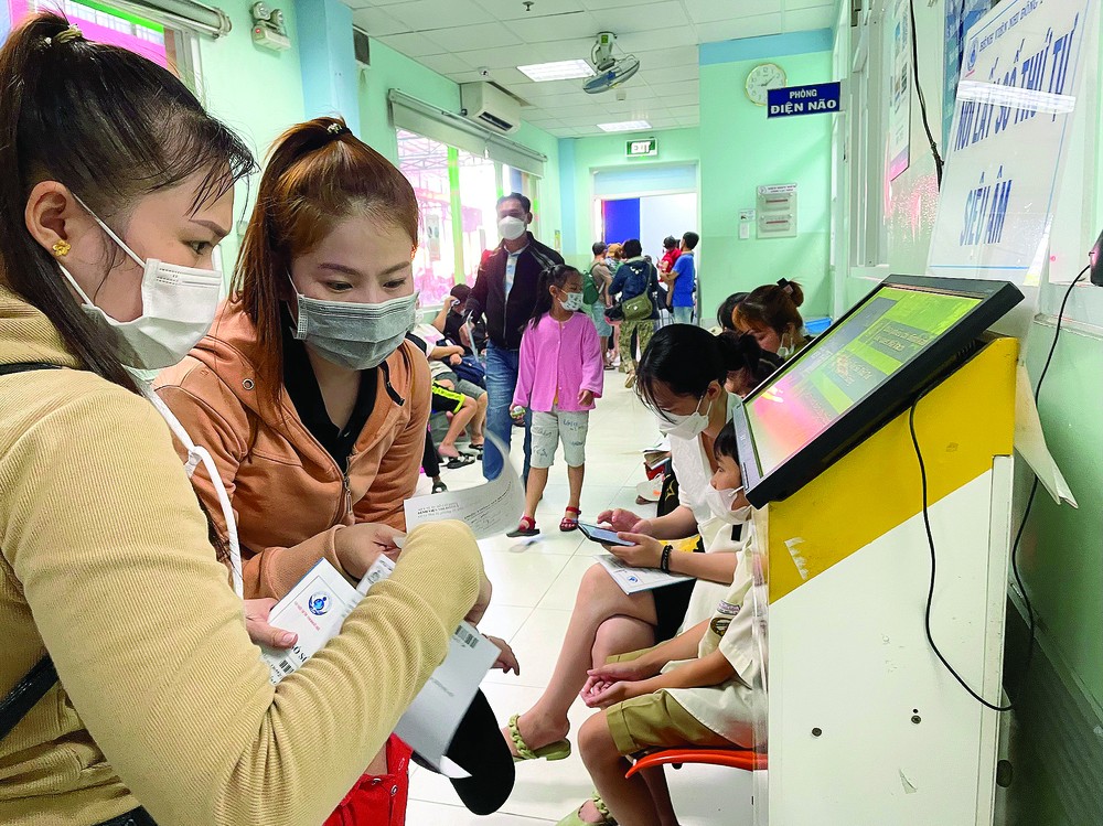 Parents take the number to see doctors at a kiosk in the Children Hospital No.1 Parents take the number to see doctors at a kiosk in the Children Hospital No.1