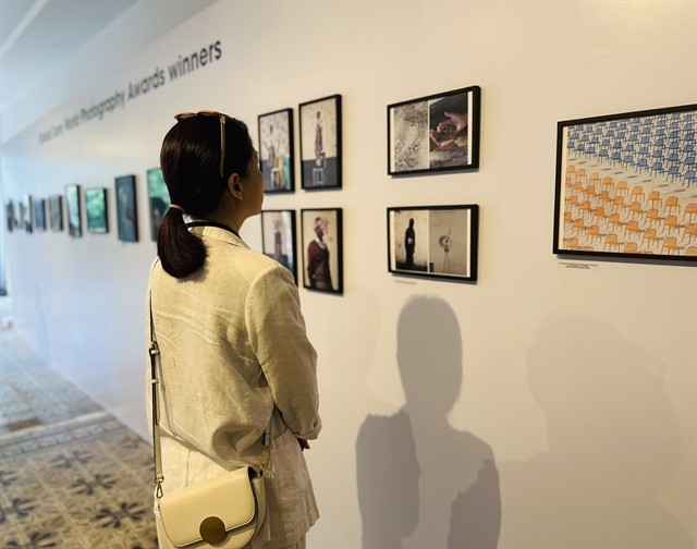 A visitor at the exhibition featuring winning entries from the Sony World Photography Awards (SWPA) from the last 10 years.