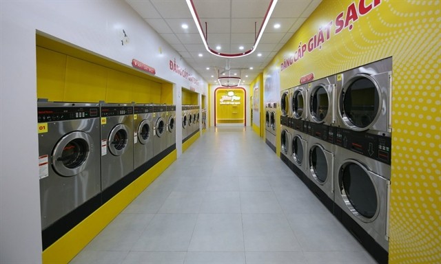 A laundromat shop opened by Masan Group. Vietnam is a huge potential market for the laundromat business. — Photo from Internet A laundromat shop opened by Masan Group. Vietnam is a huge potential market for the laundromat business. — Photo from Internet