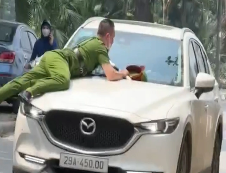 One of the police officers has to jump on the car’s hood and hold onto it to avoid impact police.png