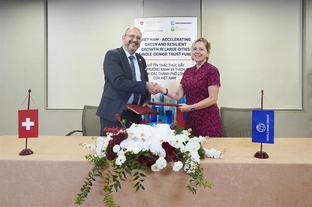 Swiss Ambassador to Vietnam Thomas Gass and World Bank Country Director for Vietnam, Cambodia and Lao, Mariam J. Sherman, at the signing ceremony of the Vietnam Accelerating Green and Resilient Growth in Large Cities Single-Donor Trust Fund. (Photo courtesy of the World Bank) wb-5452.jpg.webp