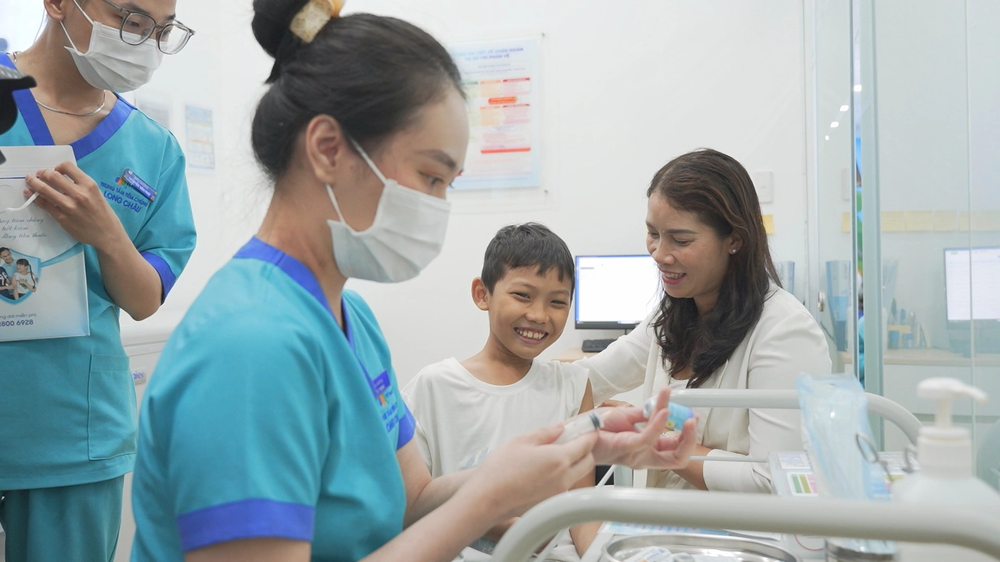 Medical workers administer a vaccine to a child. tiem-vaccine-soi-7291-3488.png.png