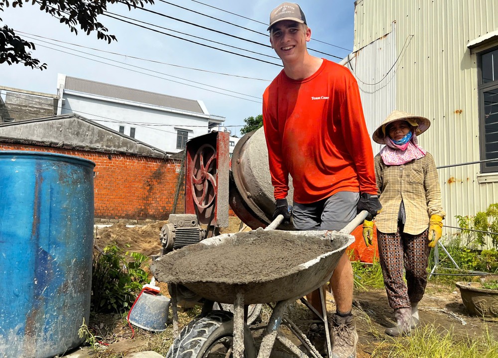 An American male student feels happy while pushing a wheelbarrow. hoc-sinh-my-28-792-2669.jpg.jpg