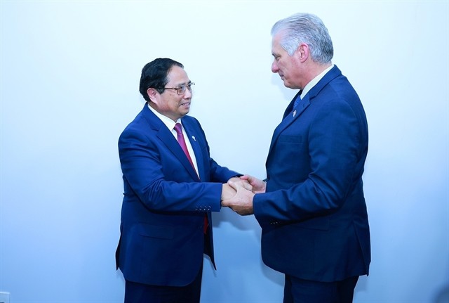 Vietnamese Prime Minister Pham Minh Chinh (L) meets with First Secretary of the Communist Party of Cuba Central Committee and President of Cuba Miguel Díaz Canel in Rio de Janeiro, Brazil, on July 6 (local time) on the sidelines of the expanded BRICS summit. (Photo: VNA) 435458_5211324204644234_cuba2.jpg