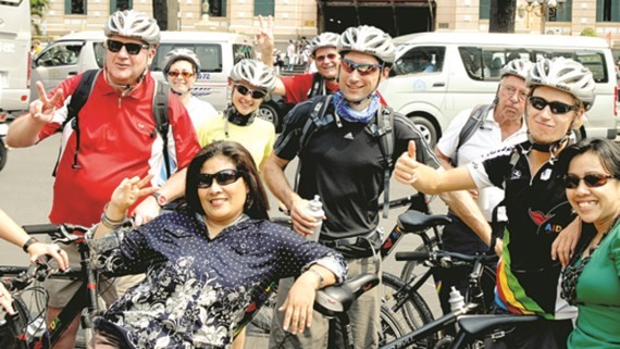 International tourists pose photo in front of Saigon Central Post Office  