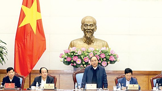 Vietnamese Prime Minister Nguyen Xuan Phuc at  a meeting about implementation of cooperation programs with Laos in 2017- 2018 (Photo:VNA)