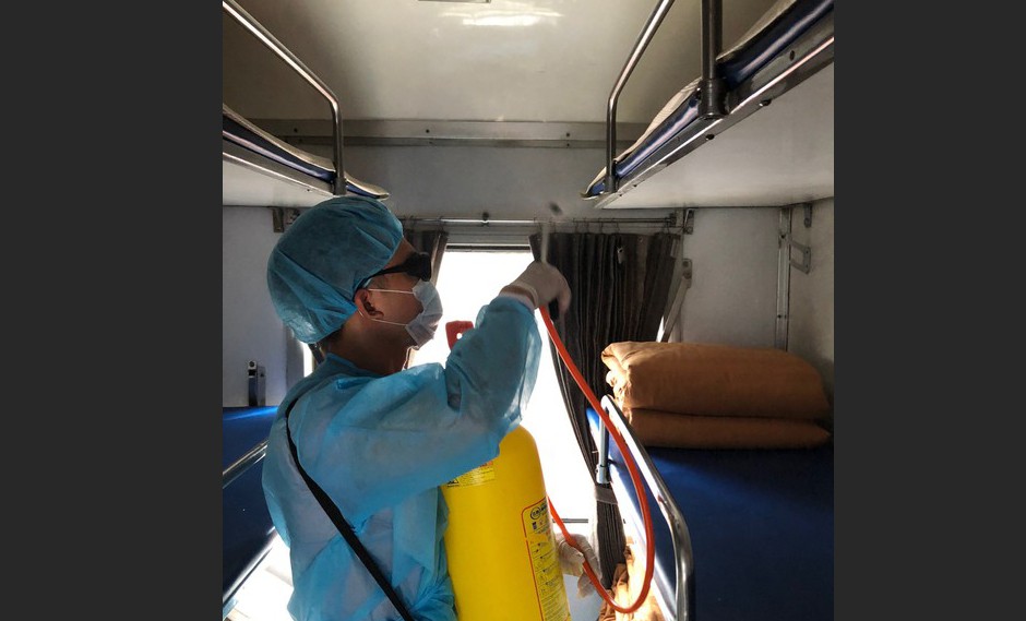 The worker disinfecting a train coach