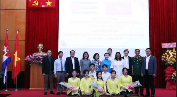 Delegates pose for a picture at the celebration.(Photo: VNA)