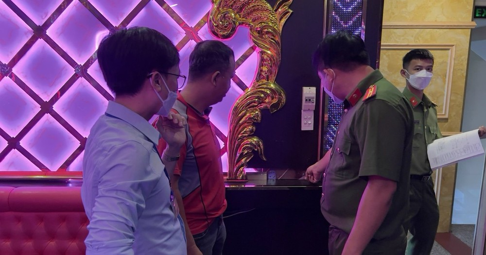 Police forces check fire safety at a karaoke facility in the city.