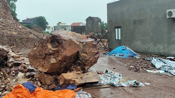 A big rock falls down the road in Truc Tay village in Bac Giang Province from the side of a mountain