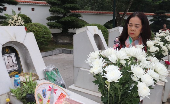 A member of the delegation sincerely offers incense at the graves of heroic martyrs.