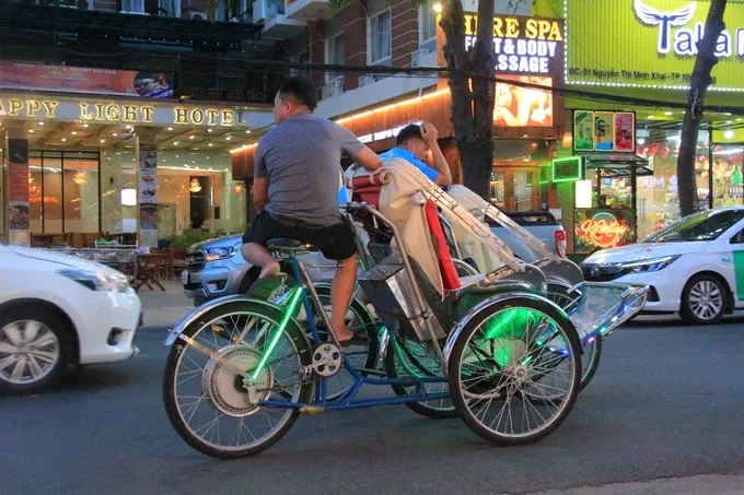 An electric rickshaw is traveling on a route of Nha Trang City. c.jpg
