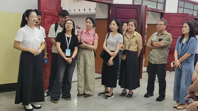The delegation is listening to a presentation about Nanning Yucai School in Guangxi, China. 2-7976-2544.jpg