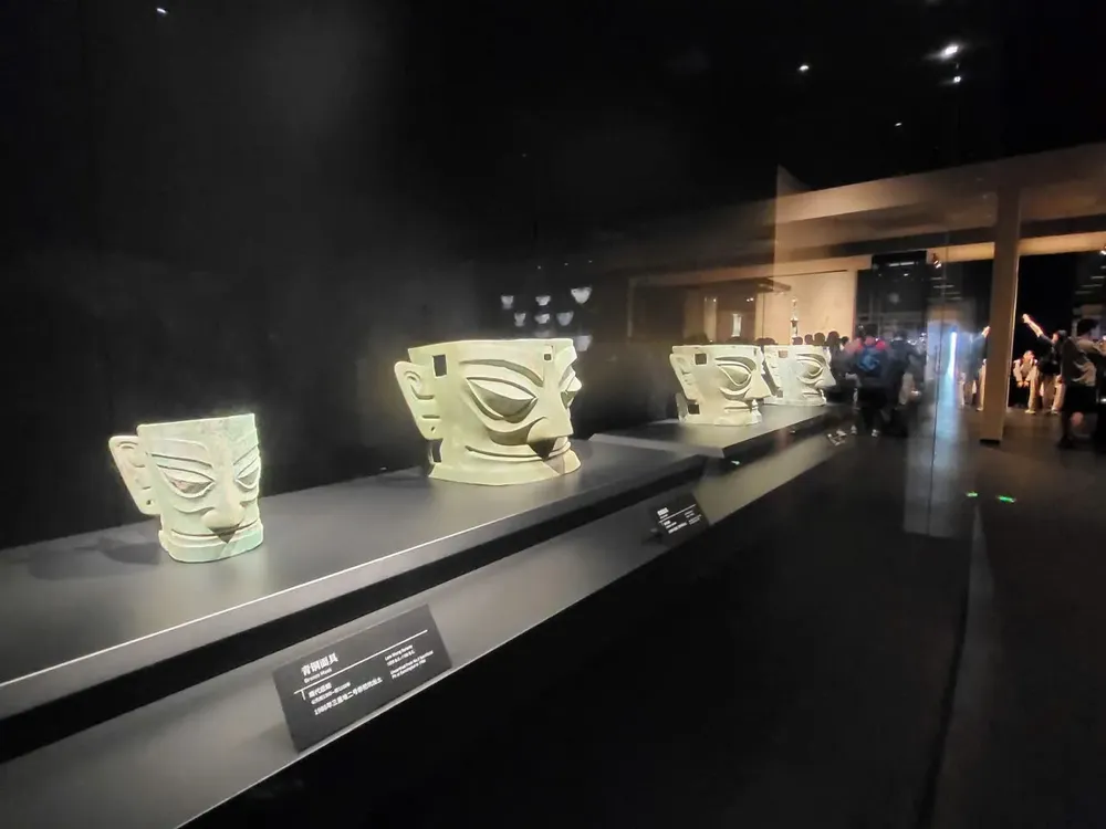 The bronze masks with bulging eyes and oversized ears are displayed at the museum. img-0592-8372-3401.jpeg