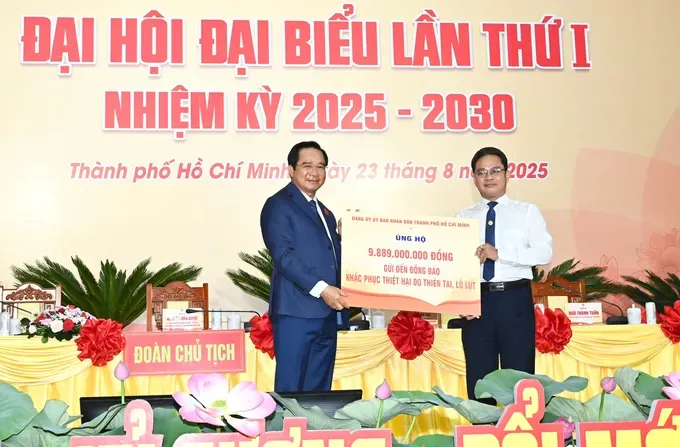 Chairman of the Ho Chi Minh City People's Committee Nguyen Van Duoc presents a symbolic check of more than VND9.8 billion (US$371,981), contributed by congress delegates and agencies under the HCMC People’s Committee Party Committee, to support communities affected by natural disasters. (Photo: Viet Dung) z6936670295775-5a9d5223b81ef22f358ceb90f81f5371-3418-6536.jpg