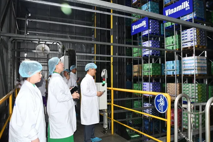 Delegates tour the warehouse at Vinamilk. dsc-02061-9873-6194.jpg