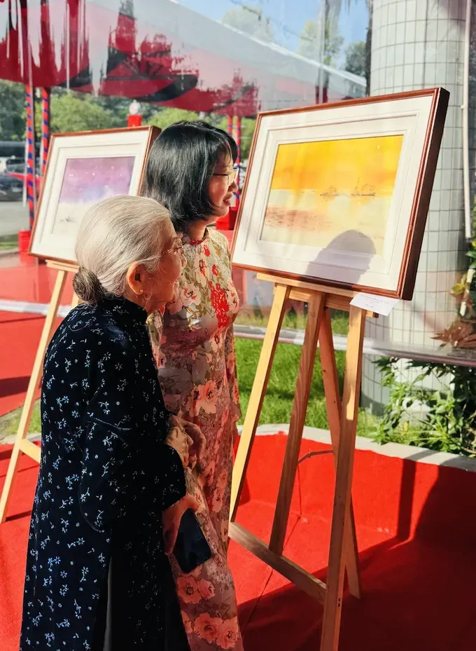 Vice Chairwoman of the Ho Chi Minh City People’s Committee Tran Thi Dieu Thuy and Meritorious Artist Phi Dieu enjoy paintings of the Truong Sa (Spratly) Islands created by reporters from Sai Gon Giai Phong Newspaper, displayed at the Press and Publishing Exhibition Space. anh-chup-man-hinh-2025-10-18-luc-082912-8138-2131.png