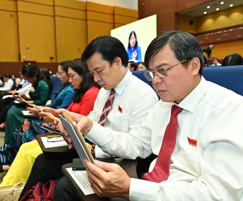 Đại biểu biểu quyết thông qua các dự thảo nghị quyết. Ảnh: VIỆT DŨNG 33.jpg