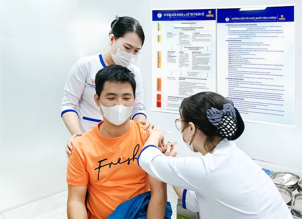 Nhân viên y tế đang tiêm vaccine cho người dân 1000005219.png
