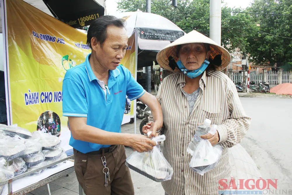 Thành viên Hội Người khuyết tật tỉnh Quảng Ngãi tặng cơm trưa miễn phí cho người lao động khó khăn. Ảnh: NGUYỄN TRANG Thành viên Hội Người khuyết tật tỉnh Quảng Ngãi tặng cơm trưa miễn phí cho người lao động khó khăn. Ảnh: NGUYỄN TRANG