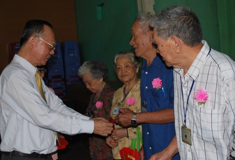 穗城會館理事長盧耀南向高齡鄉親頒發利是。（圖源：趣兒）