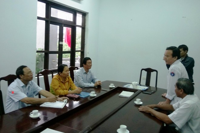 承天-順化省新聞與傳播廳代表人(右二)向黃功傳(左)醫生道歉。（圖源：ĐT）