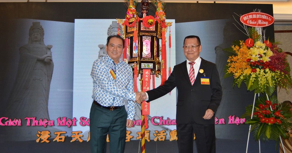 張敬和理事長(右)向“天后娘娘”聖燈得主林松耀移交聖燈。 (燕農/攝)