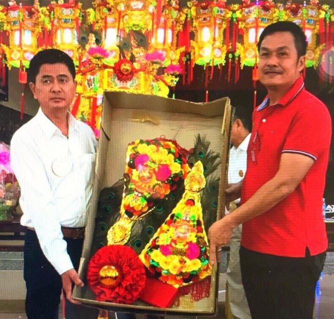 陳昶霖(右)向陳良轉交“大紅金花。