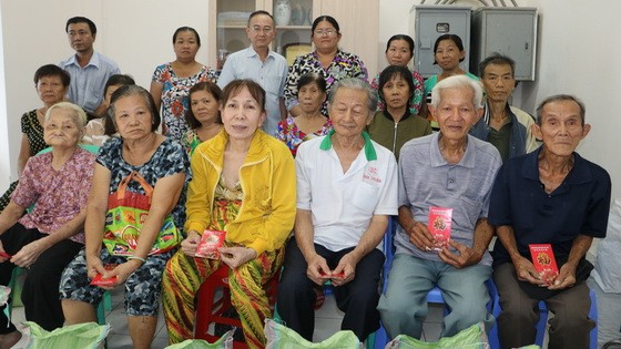 范興主任(後排左三)向貧困戶贈送禮物。