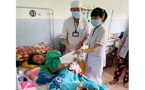 范玉石醫院社會工作科代表向窮困病人贈送輔助金。