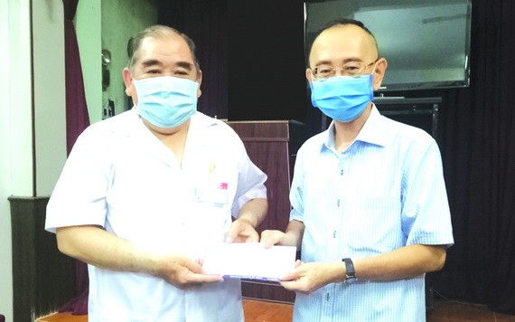 范興主任(右)轉贈本報讀者捐助的善款。