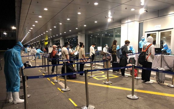 從美國加州撤回的同胞抵達廣寧省雲屯機場時辦理健康申報手續。（圖源：VNA）