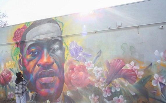 一名女子在喬治‧弗洛伊德的壁畫前表達敬意。（圖源：路透社）