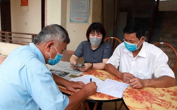 一名市民在簽領紓困金。（圖源: 越通社）