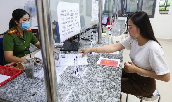 民眾帶著戶口簿到第三郡公安辦理芯片公民身份證手續。