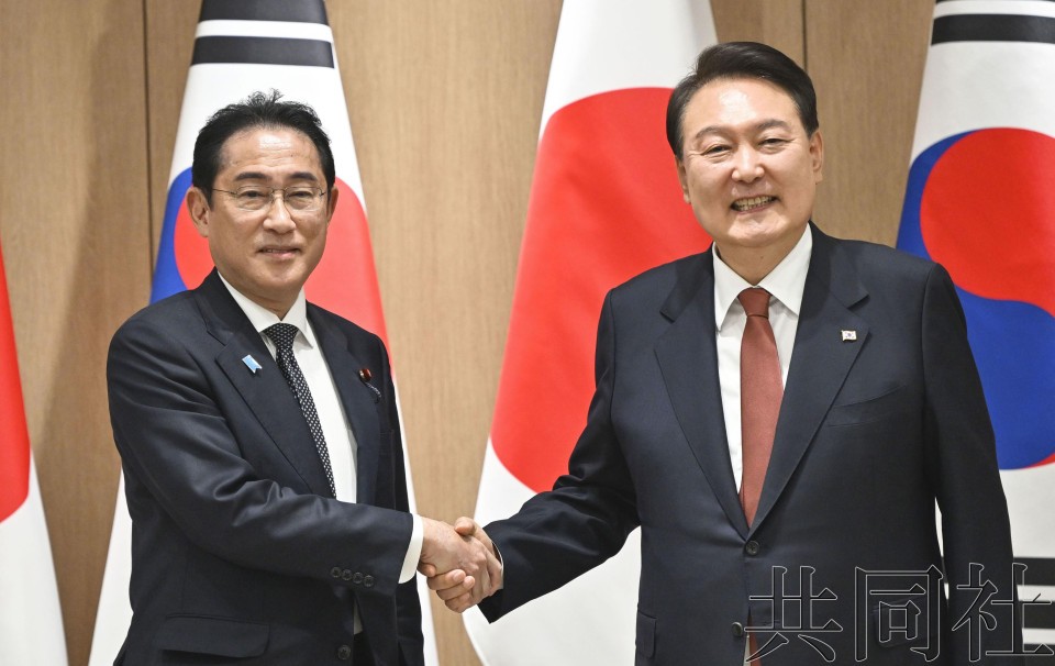 5月7日，日本首相岸田文雄（左）与韩国总统尹锡悦会谈时握手。（图：共同社）