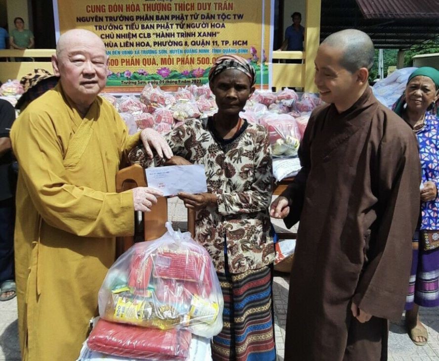 莲华寺住持释惟镇法师代表慈善团向贫困者派发礼物。