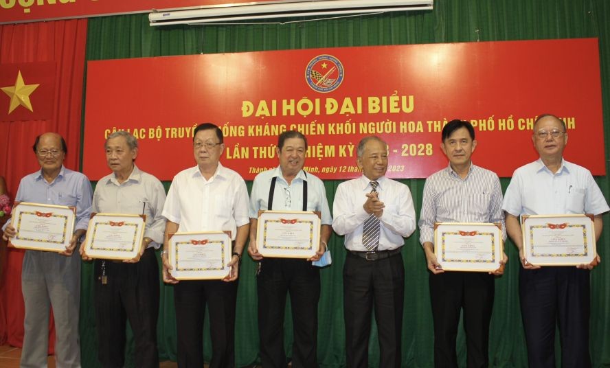 市抗战传统俱乐部主任杨关河（右三）向各华人会馆颁发奖状。