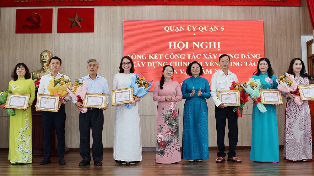 市委副书记、人民议会主席阮氏丽和第五郡郡委书记黄玉女芳红向出色集体颁发奖状。