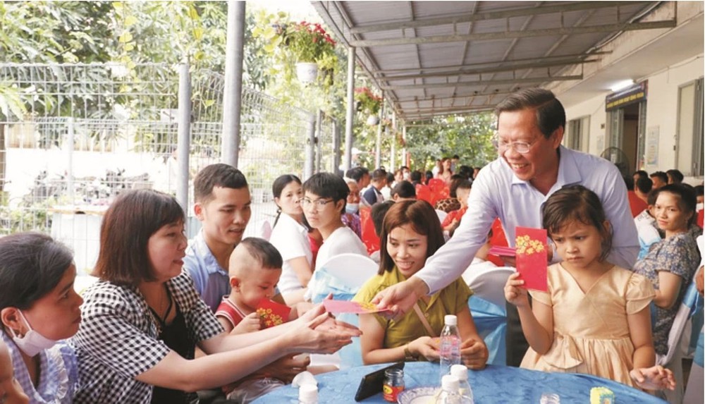 市人委会主席潘文迈在芽皮县协福工业区工人住宿区赠送压岁钱给没回家过年的工人。